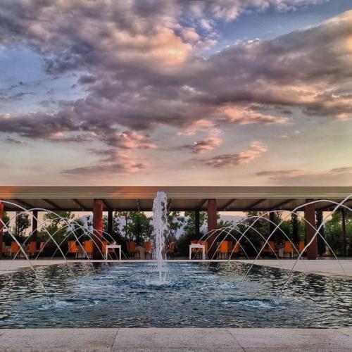 a fountain in a park under a cloudy sky at Hotel Liola' in Castrocielo