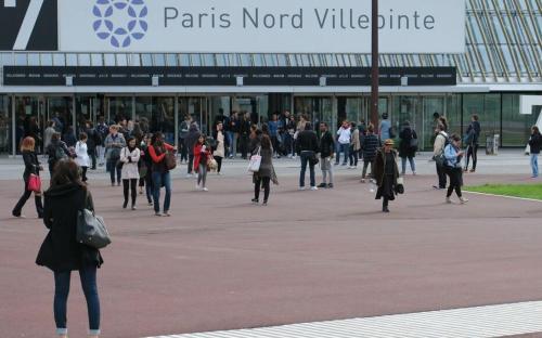 a crowd of people walking in front of a building at HOTEL DU PARC in Aulnay-sous-Bois