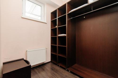 a closet with a brown door in a room at ERA RENT Apartments in Chişinău