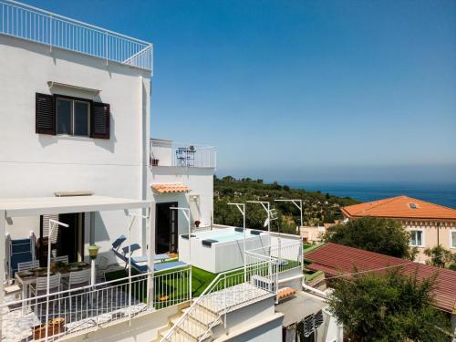a white building with a view of the ocean at Relais Francesca Pool&View in Sorrento