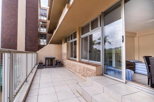 a balcony with large windows and a patio at ATKV Natalia in Kingsburgh
