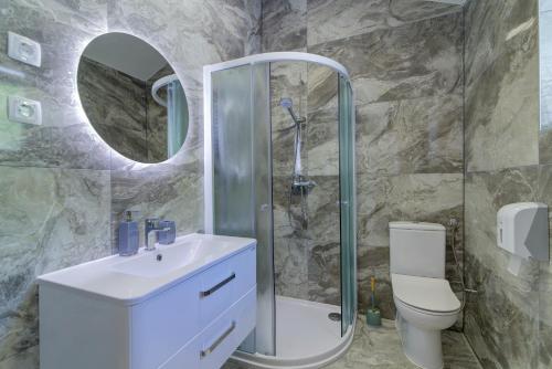 a bathroom with a shower and a sink and a toilet at Apartmani Maka in Senj