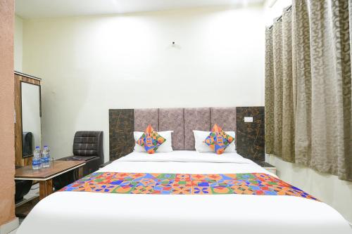 a bedroom with a bed and a desk and a mirror at Via Galaxy in Chandīgarh