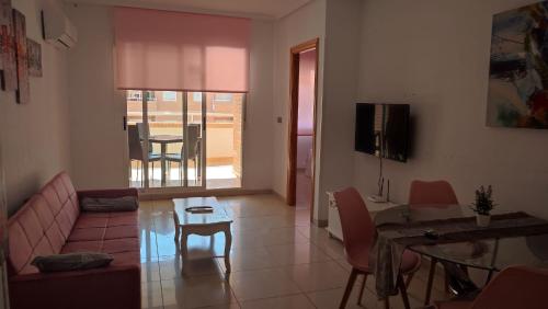 a living room with a couch and a table at Apartamentos varios con 2 dorm en Marina Dor , la playa de Amplaries 47 , vista lateral al mar in Oropesa del Mar