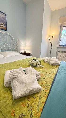 a bedroom with a bed with towels on it at A casa di Iole in Fiumicino