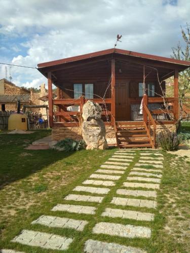a log cabin with a pathway leading to the front porch at Apartamento El Paso in Fuentelisendo