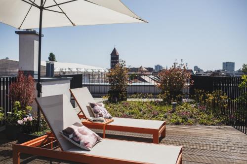 two chairs and an umbrella on a roof at The Circus Apartments in Berlin