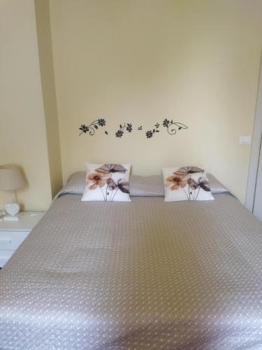 a bedroom with a bed with two pillows on it at Villa Fontana in Capannori