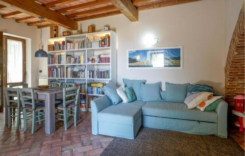 a living room with a blue couch and a table at Beautiful Home In Serravalle Pistoiese in Serravalle Pistoiese