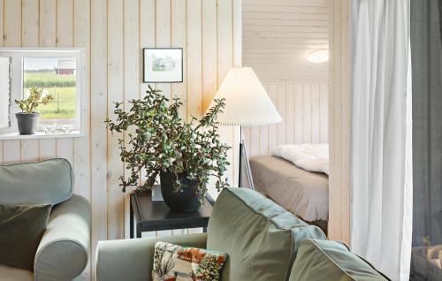 a living room with a couch and a bed at Stunning Home In Rødby With Wifi in Rødby