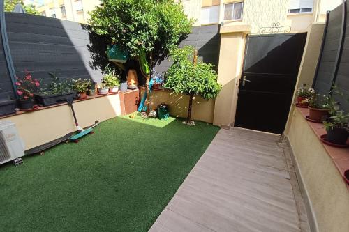 un petit jardin avec de l'herbe et des plantes dans un bâtiment dans l'établissement Charming T5 with garden and terrace, à Nice