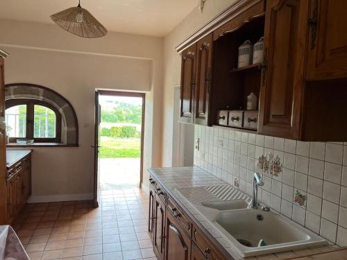 a kitchen with a sink and a counter top at Belle Maison avec vue magnifique , séjour pleine nature gd jardin in Cressat