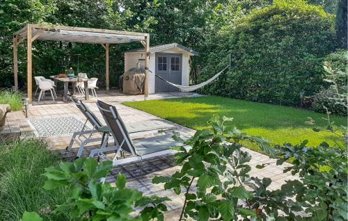 a patio with a hammock in a garden at Cozy Apartment In Lieren With Wifi in Loenen