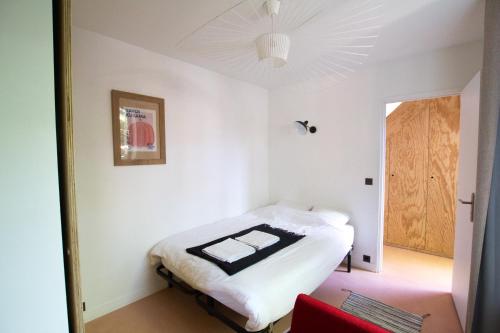 a bedroom with a bed in a room with a ceiling at Bright & Eco-Friendly Wooden Home, A Peaceful Retreat Near Paris in Montreuil