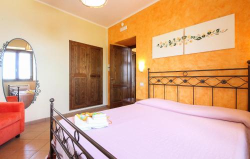 a bedroom with a large bed and a red couch at Pet Friendly Home In Laureana Cilento in Laureana Cilento