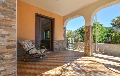an open door to a patio with a bench at Appartamento Scarantino 2 in Catania