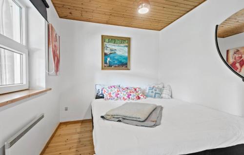 a bedroom with a white bed and a window at Nice Home In Faxe Ladeplads With Wifi in Fakse Ladeplads