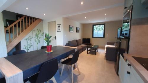 a kitchen and living room with a couch and a table at Mas Sansonnets in Mouriès