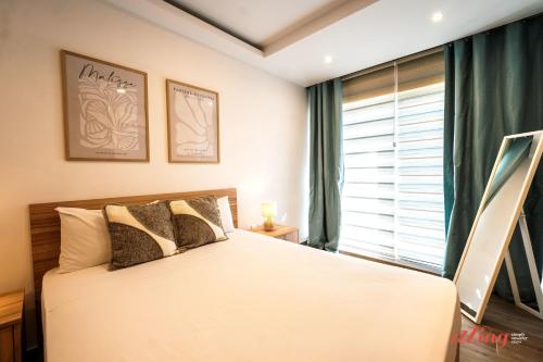 a bedroom with a bed and a large window at Stylish Retreat in a Charming Maltese Village in Għargħur