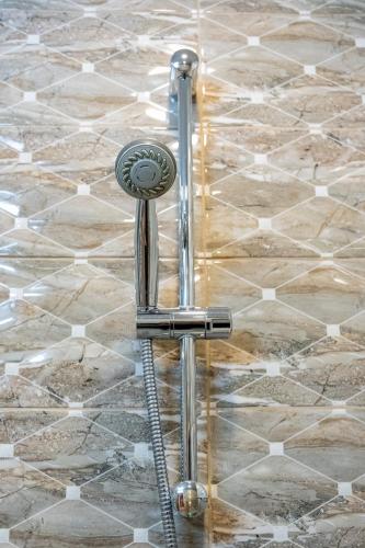 a shower in a bathroom with a water hose at Daya 2BR Luxury Apartment in Varna City