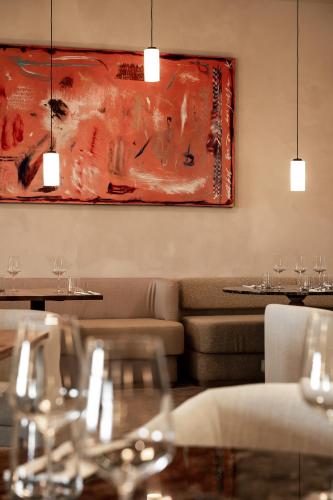 a restaurant with a couch and a painting on the wall at Forest Hotel in Kraków