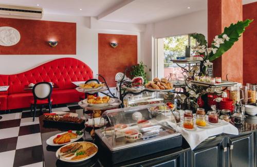 a buffet of food in a hotel room at Hôtel Liberata & Spa in LʼÎle-Rousse