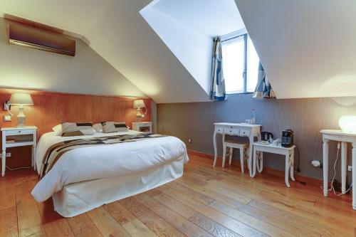 a bedroom with a large bed and two tables at Champagne Domaine Sacret - AY in Épernay