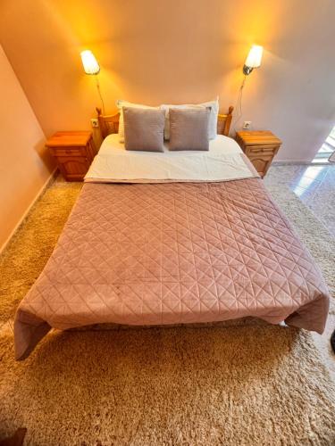 a bedroom with a large bed with two pillows at MOTEL INTERNATIONAL in Berkovitsa