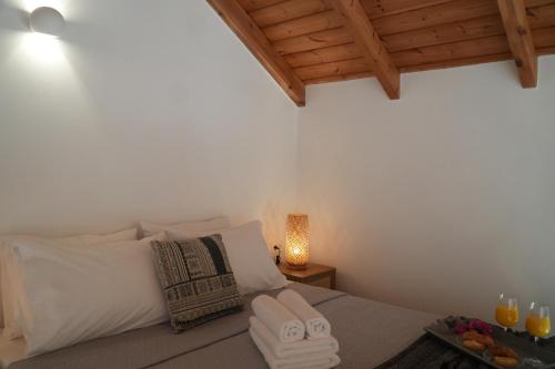 a bedroom with a bed and a table with glasses of orange juice at Bella Vista in Symi