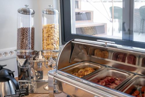 a container of food on a counter next to a window at Miss Marrone City Hotel in Chania Town