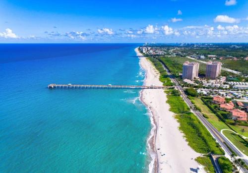 an aerial view of a beach with a pier at 4br Private Guest Suite Pool Pga Beaches in Palm Beach Gardens