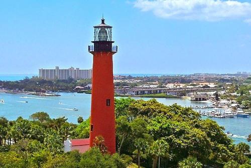 a red lighthouse sitting on top of a hill at 4br Private Guest Suite Pool Pga Beaches in Palm Beach Gardens