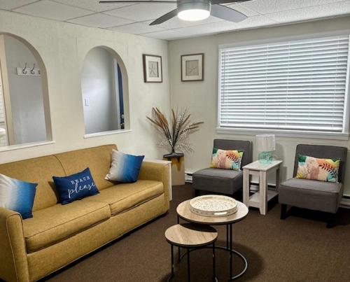 a living room with a couch and two chairs at Horizon Motor Inn-Beach Block & Close to Morey's Piers in North Wildwood
