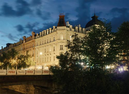 a large building on a bridge at night at IMPERIAL Apartments in Karlovy Vary