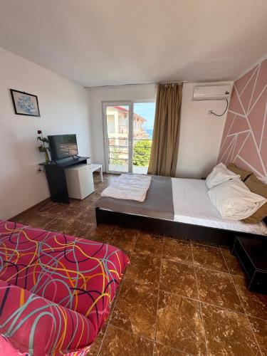 a bedroom with a large bed and a window at Casa Roman II by the sea in Costinesti