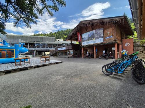 a blue motorcycle parked in front of a building at Chalet MON FRERE in Le Biot