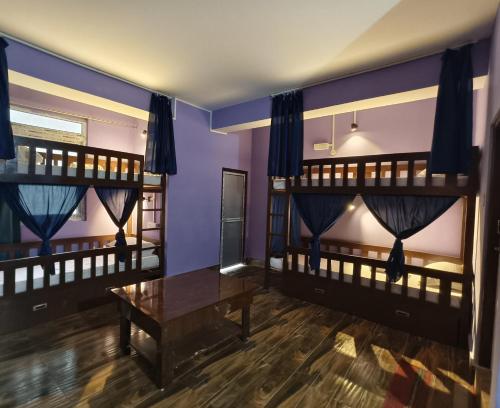 a room with two bunk beds and a table at SHARTHI HOMESTAY AND LODGING in Namchi