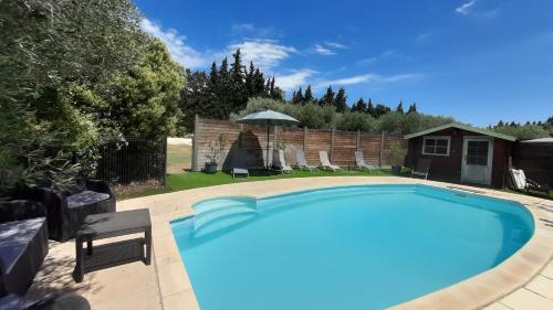 a large swimming pool in a yard with a house at Mas Sansonnets in Mouriès