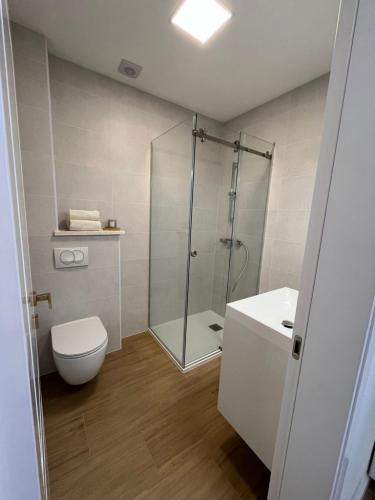 a bathroom with a shower and a toilet and a sink at Apartments Laura in Korčula