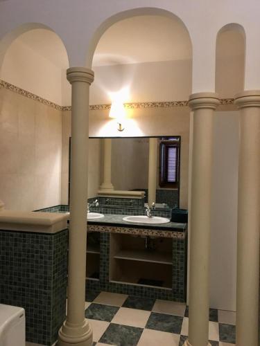a bathroom with two sinks and a large mirror at Casa Cerasoli Gallipoli in Gallipoli