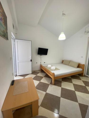 a bedroom with a bed and a checkered floor at Vila Vavilon in Star Dojran