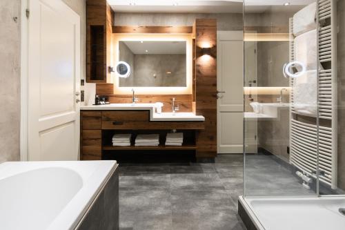 a bathroom with a sink and a mirror at POST Family Resort in Unken