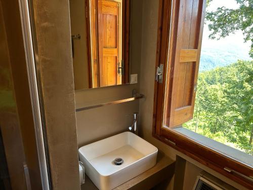 a bathroom with a sink and a window at B&b Casa Rioletta in Bologna