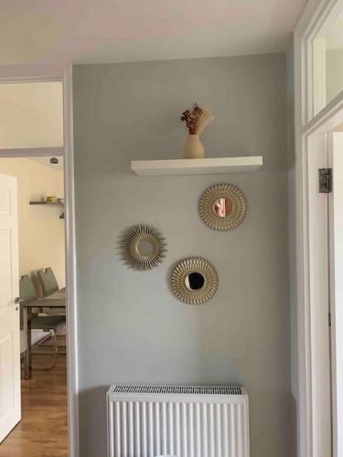 three mirrors on a wall in a room at 2 Bed Apartment, Southgate, London in East Barnet