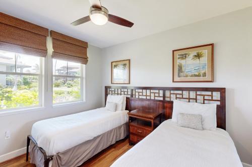 two beds in a room with two windows at Halii Kai 18E - Waikoloa in Waikoloa