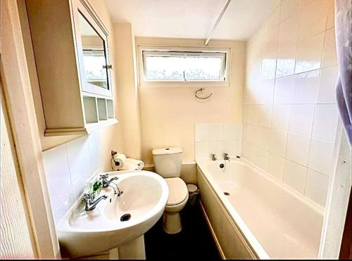 a bathroom with a sink and a toilet and a tub at Spacious cabin, near Padstow and 7 Bays in St Merryn