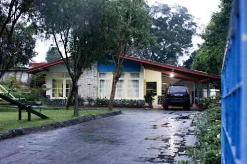 a car parked in front of a house at Rumah Engkong Villa & Studio in Bandungan