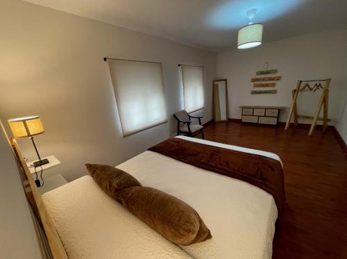 a bedroom with a bed with a pillow on it at Calo's Place in Fisterra