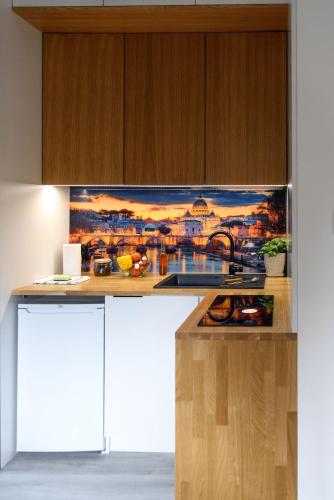 a kitchen with a painting on the wall at Tylawa - Domki w Beskidzie Niskim in Tylawa