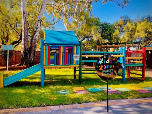 a playground with colorful play equipment in a park at LA Diamond Lodge & Safari in Lime Acres